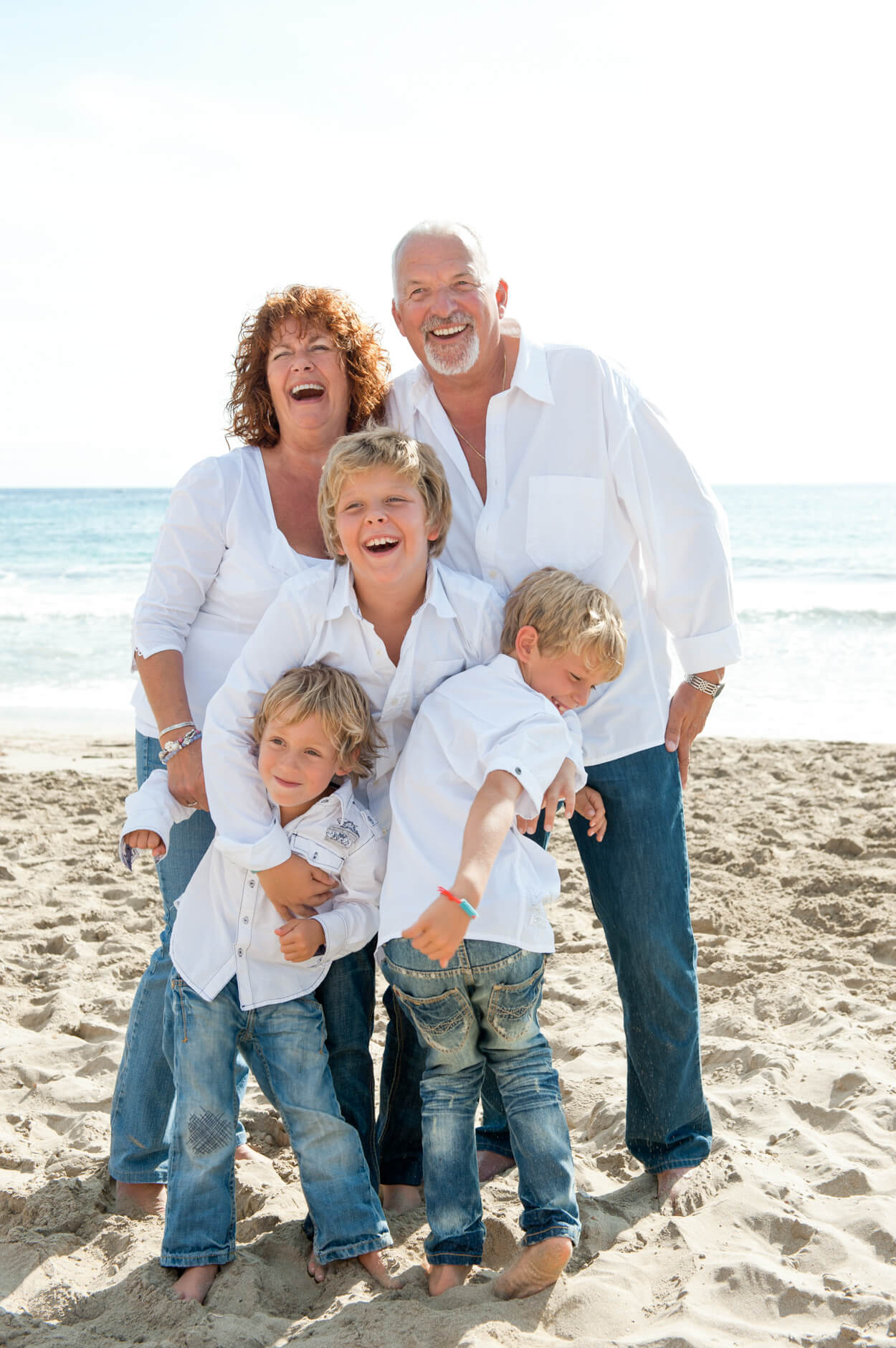 beach portrait grandparents kids white shirts jeans laughing morning light