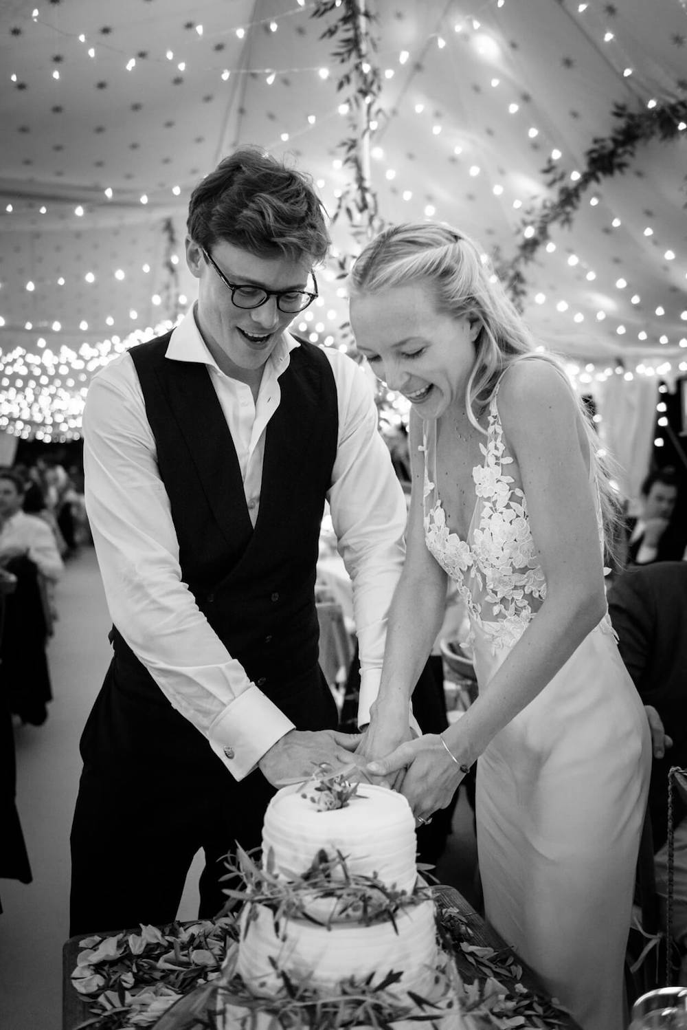 bride groom cutting cake olive tree decoration festoon lighting
