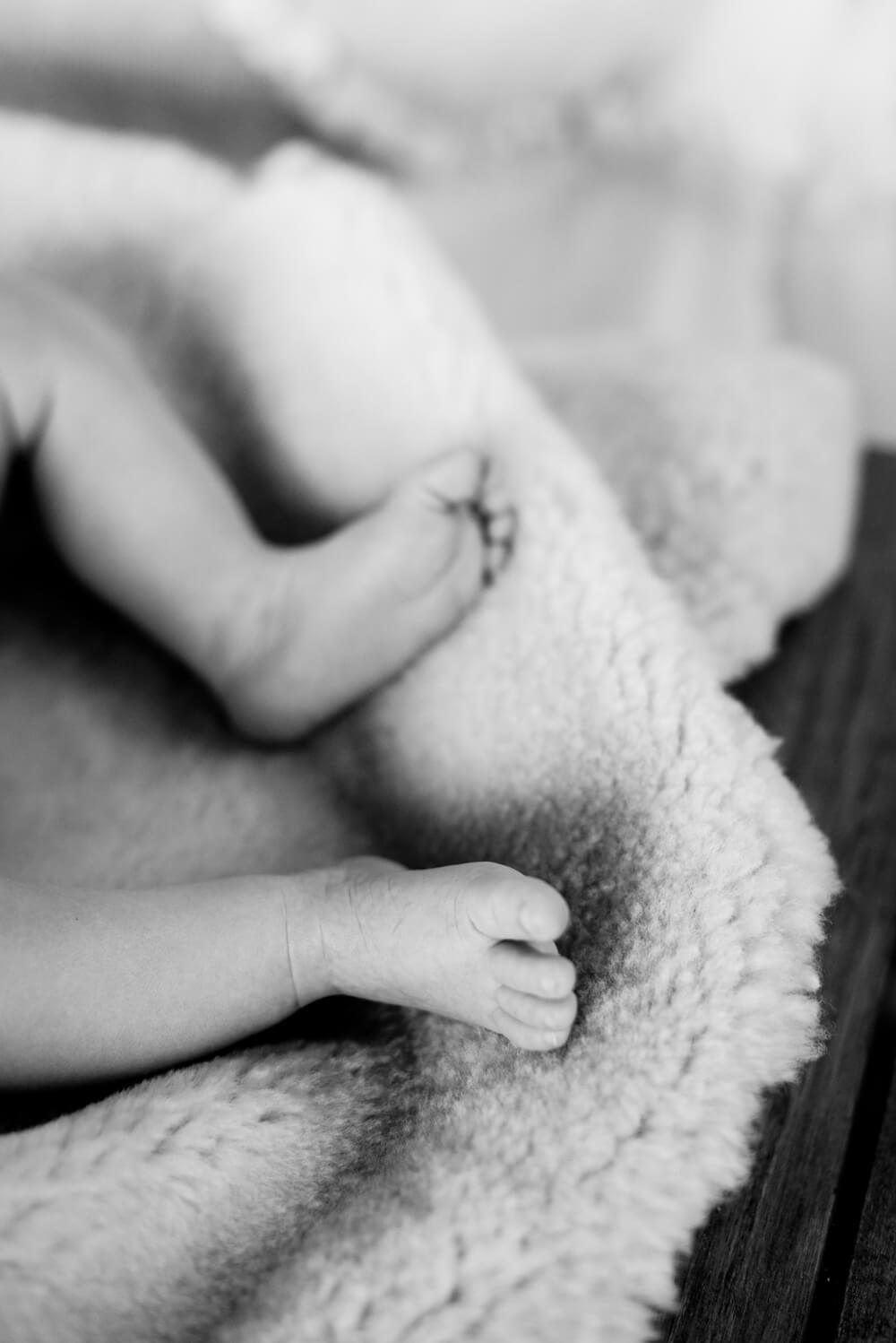 black and white image of a newborn baby's feet
