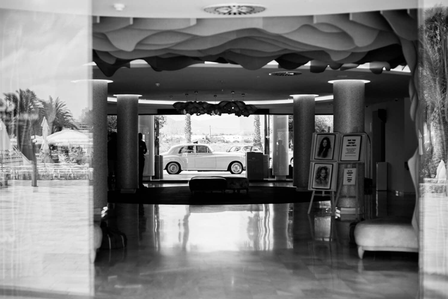 black and white photograph of a classic car at a wedding venue in Ibiza