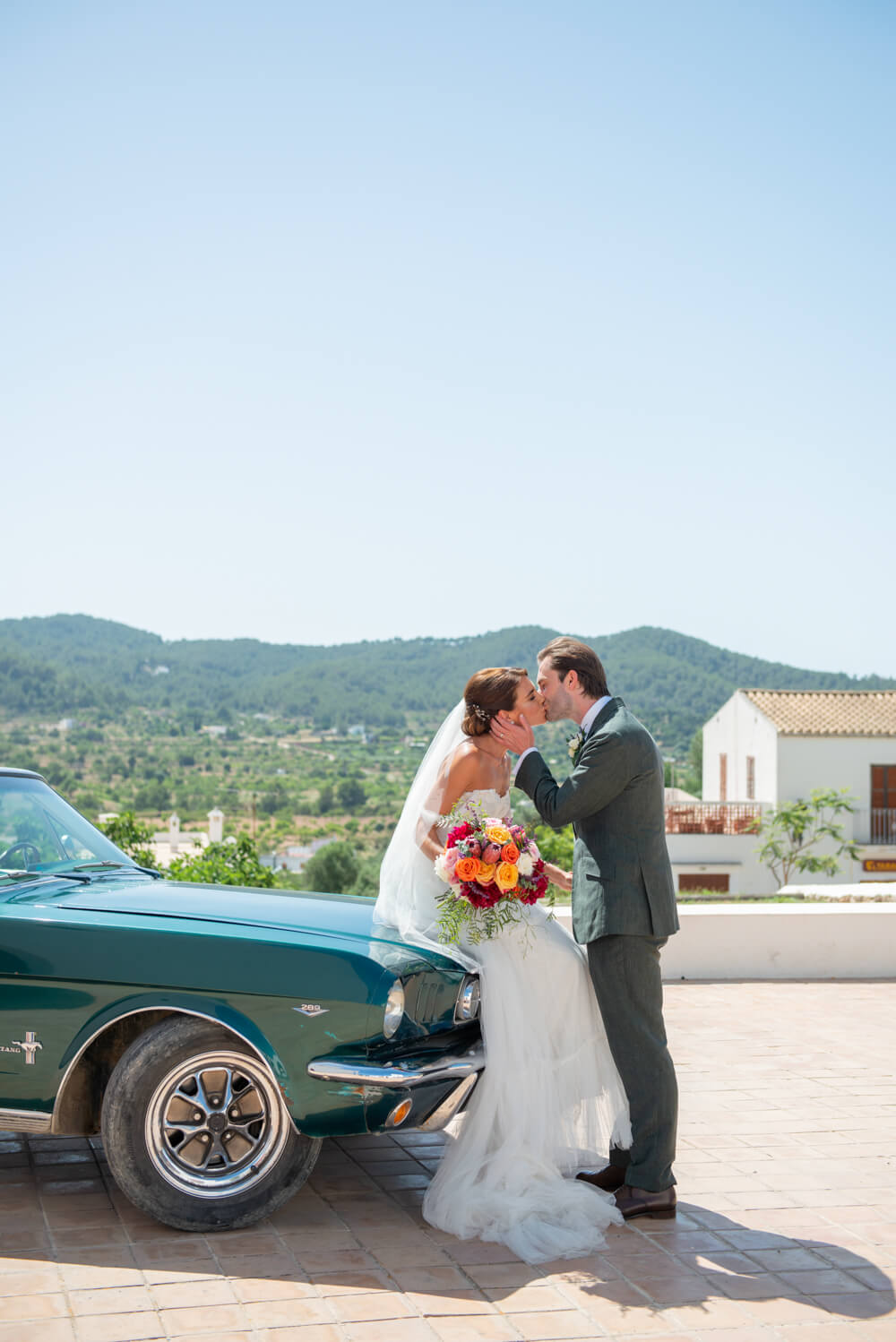Bride and Groom By their wedding car at San Augustin Church in Ibiza