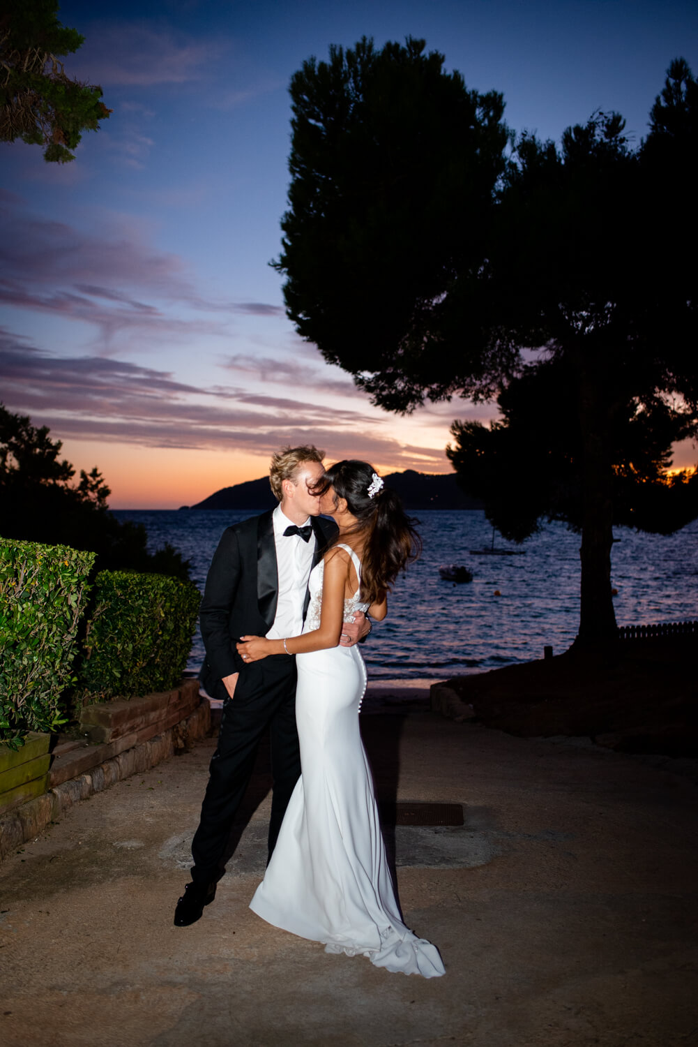 bride and groom kissing at sunset nikki beach ibiza