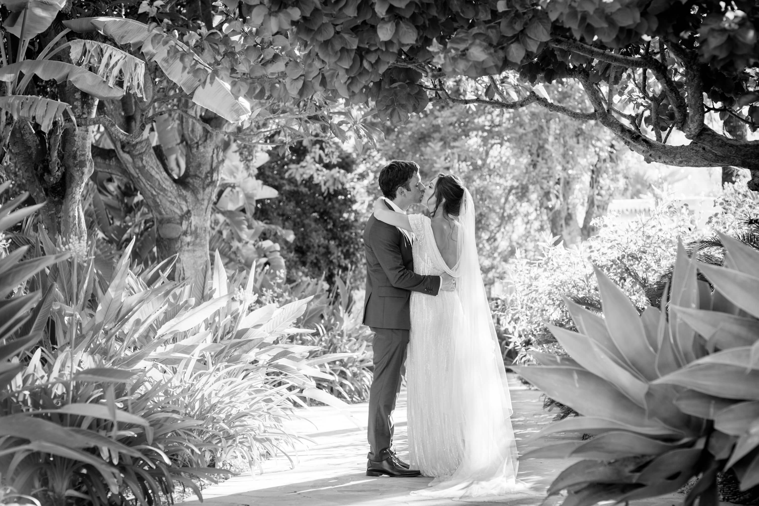 Bride and Groom kissing in the garden of Hotel Can Gall Ibiza wedding
