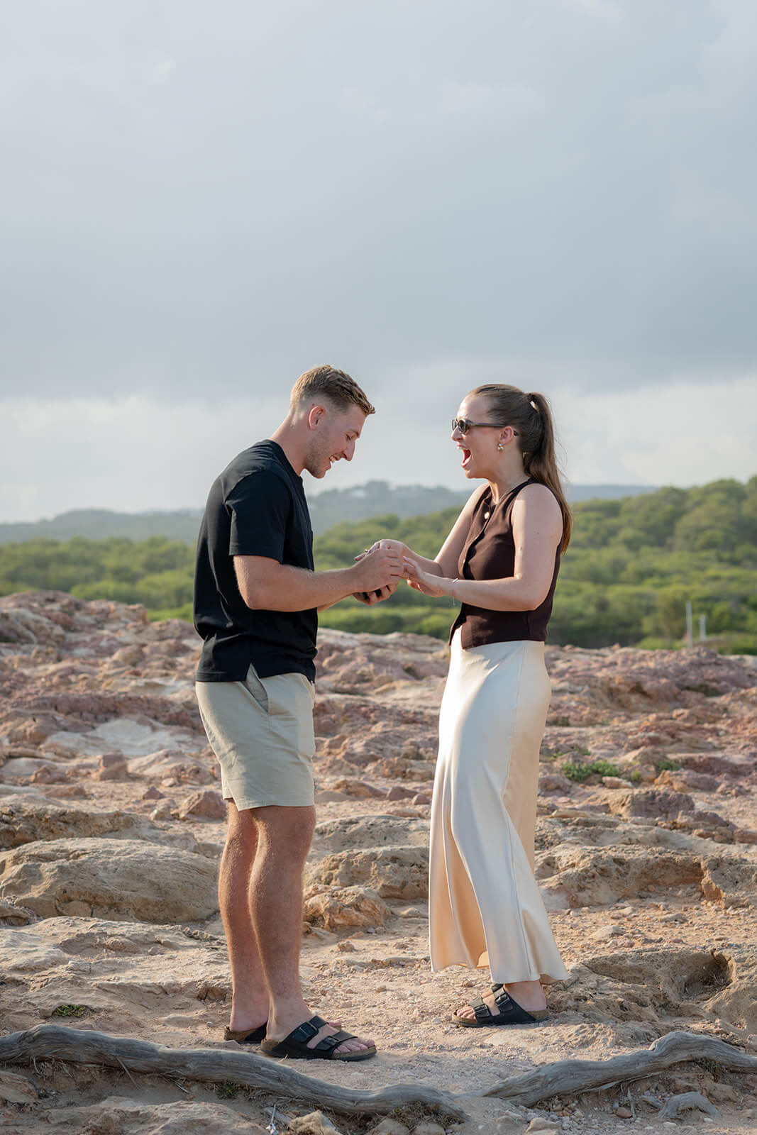 C+M _ Gypsy Westwood HL-9_websize Couple stand holding hands after marriage proposal on the cliffs of Ibiza