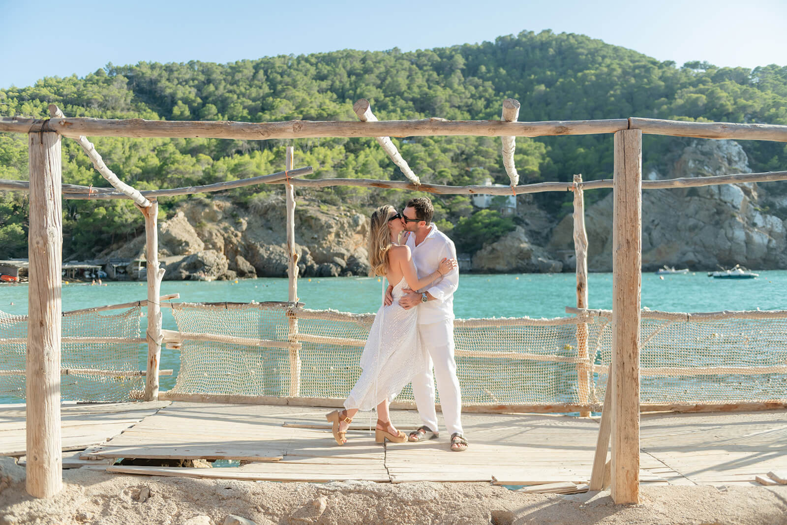 N+L _ Gypsy Westwood h-6_websize Couple stand kissing at Benirras beach in Ibiza after marriage proposal