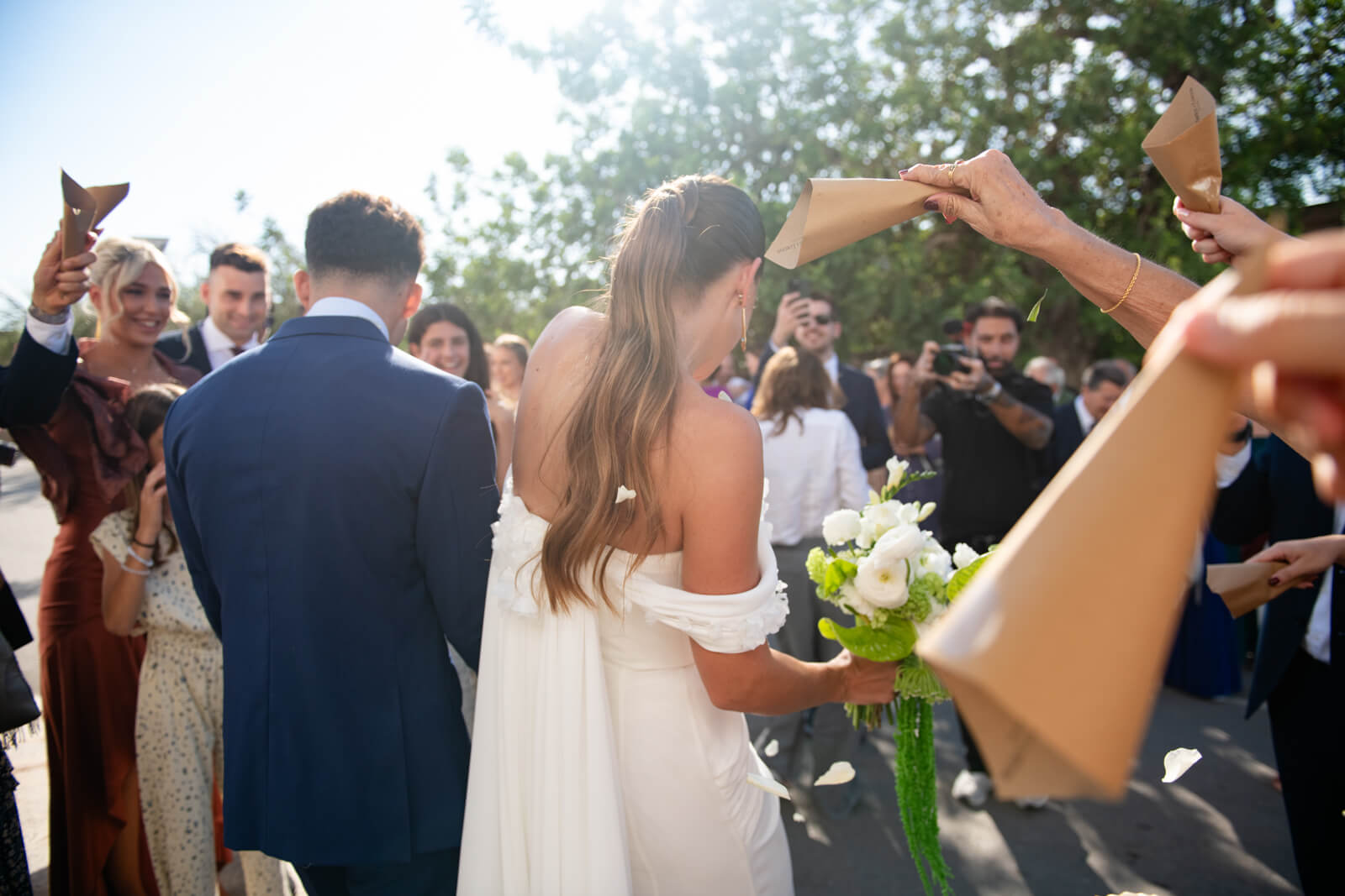 bride and groom, newly weds! walk out of church ceremony to family, friends and confetti in ibiza
